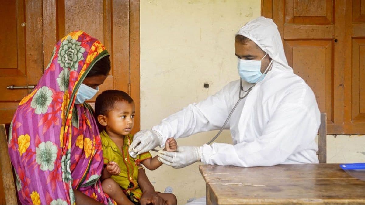 Health worker examining a child