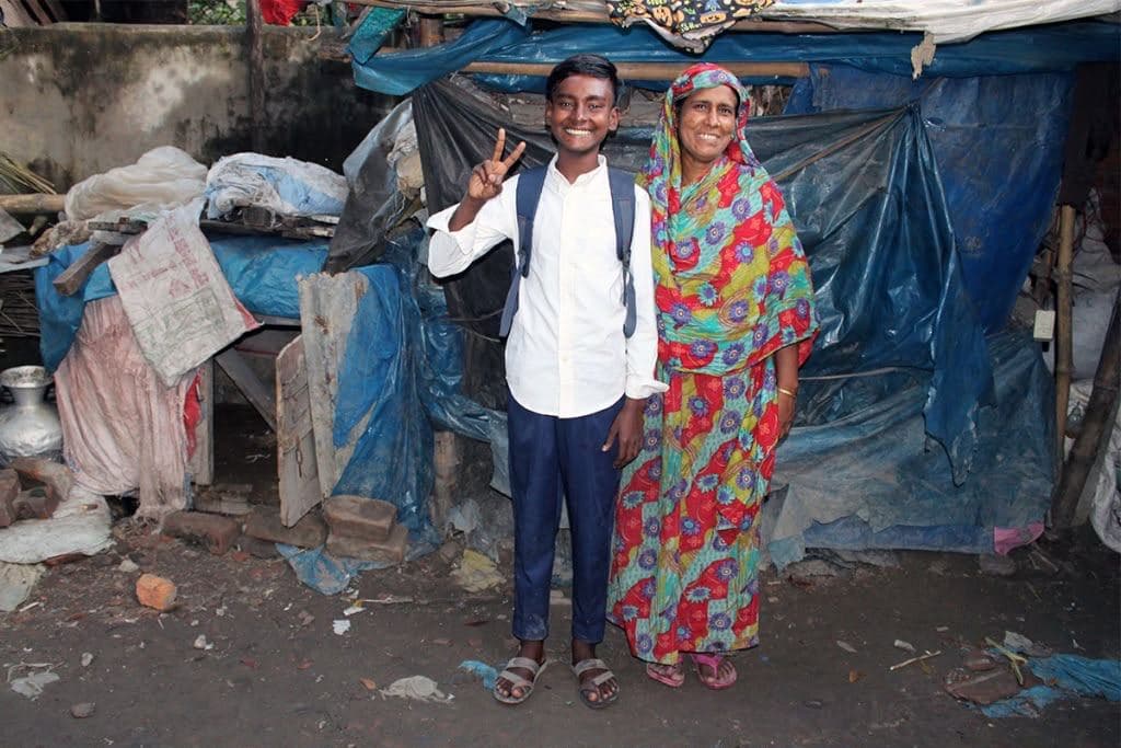A couple in front of their home