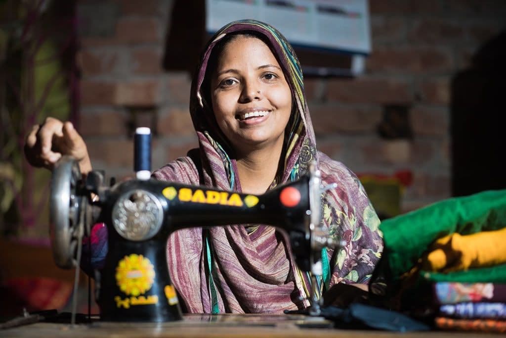 Woman smiling at her sewing machine